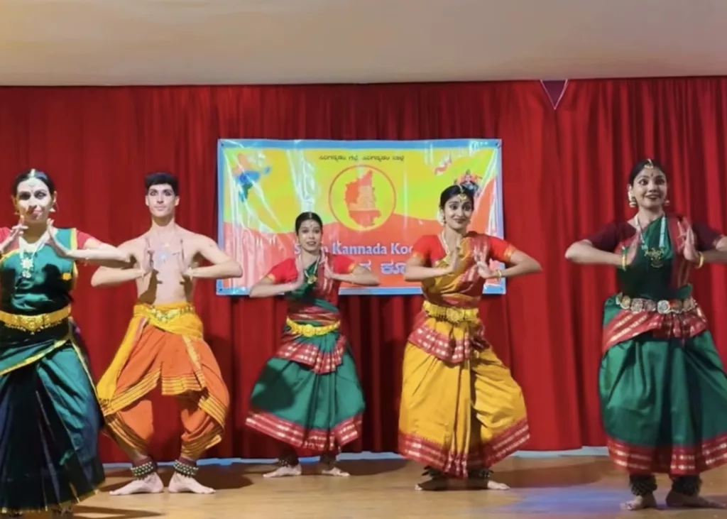 Group of dancers for the Ganesh Chaturthi Barcelona 2025. Performing for kannara asociation in Barcelona. Four girls and Francisco Valiente posing with a bharatanatyam pose on the stage while the audience is watching them dance.