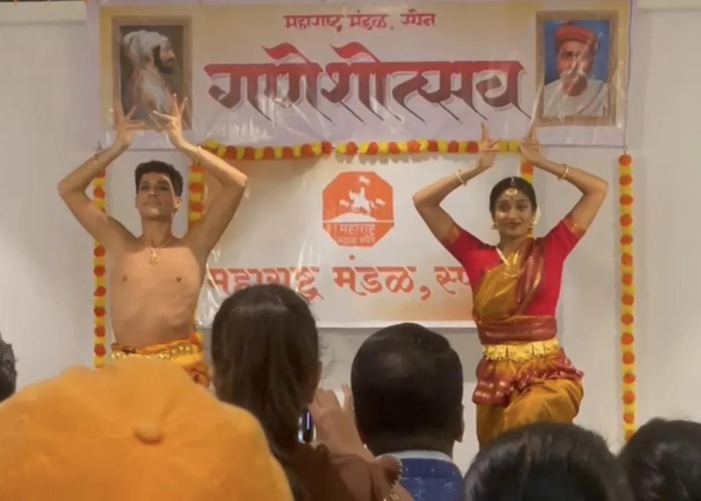 Group of dancers for the Ganesh Chaturthi Barcelona 2025. Performing for marathi asociation in Barcelona. Four girls and Francisco Valiente posing with a bharatanatyam pose on the stage while the audience is watching them dance.