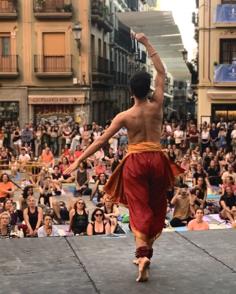Francisco Valiente, bharatanatyam teacher and performer from Madrid dancing on the stage in Plaza de las Pasiegas, Granada. Celebrating the Day of Yoga 2026.