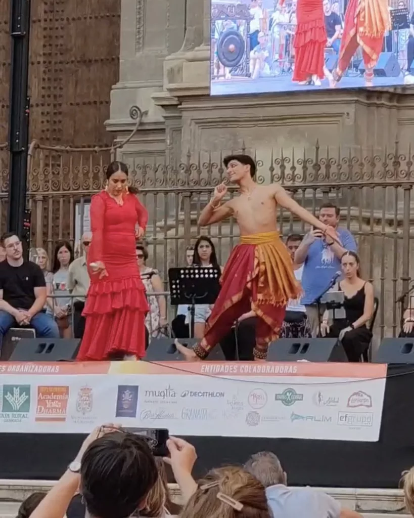 Francisco Valiente, bharatanatyam teacher and performer from Madrid dancing on the stage along with a flamenco female dancer in Plaza de las Pasiegas, Granada. Celebrating the Day of Yoga 2026.