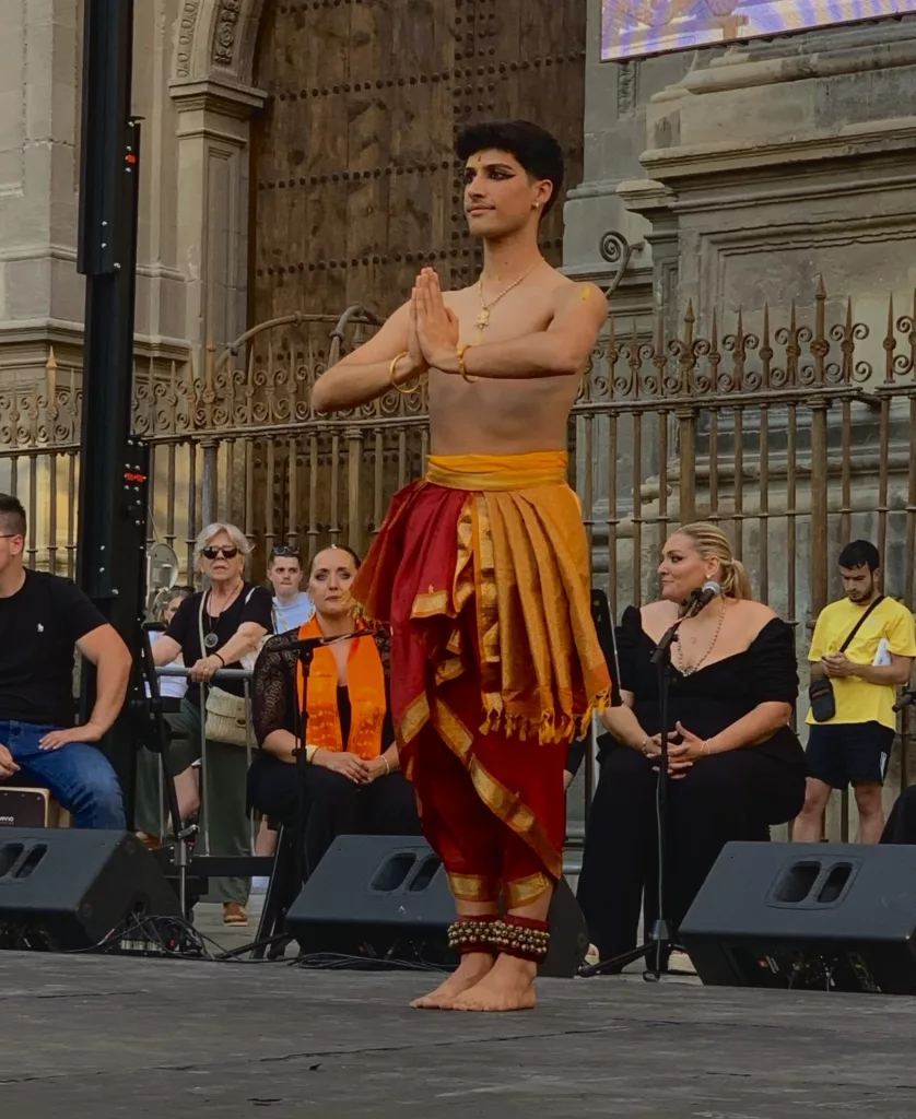 Francisco Valiente, bharatanatyam teacher and performer from Madrid standing on the stage in Plaza de las Pasiegas, Granada. Celebrating the Day of Yoga 2026.